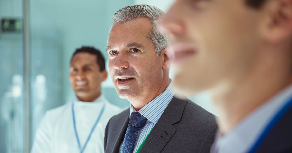 A pharmaceutical investor tours a CDMO facility to learn more about a promising new drug development project. 